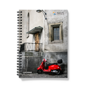 a red motorcycle parked in front of a building