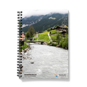 a spiral notebook with a river running through it