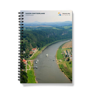 a spiral notebook with a photo of a river