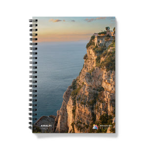 a spiral notebook with a scenic view of the ocean