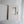a white box with a cutout, possibly containing a small object or a compartment, placed on a white surface.