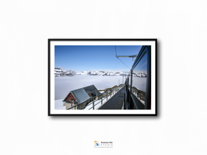 a framed photograph of a snowy mountain range