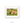 A brown, shaggy-haired animal, possibly a yak or a similar species, is lying down on a grassy field.
