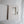 a white box with a cutout, possibly containing a small object or a compartment, placed on a white surface.