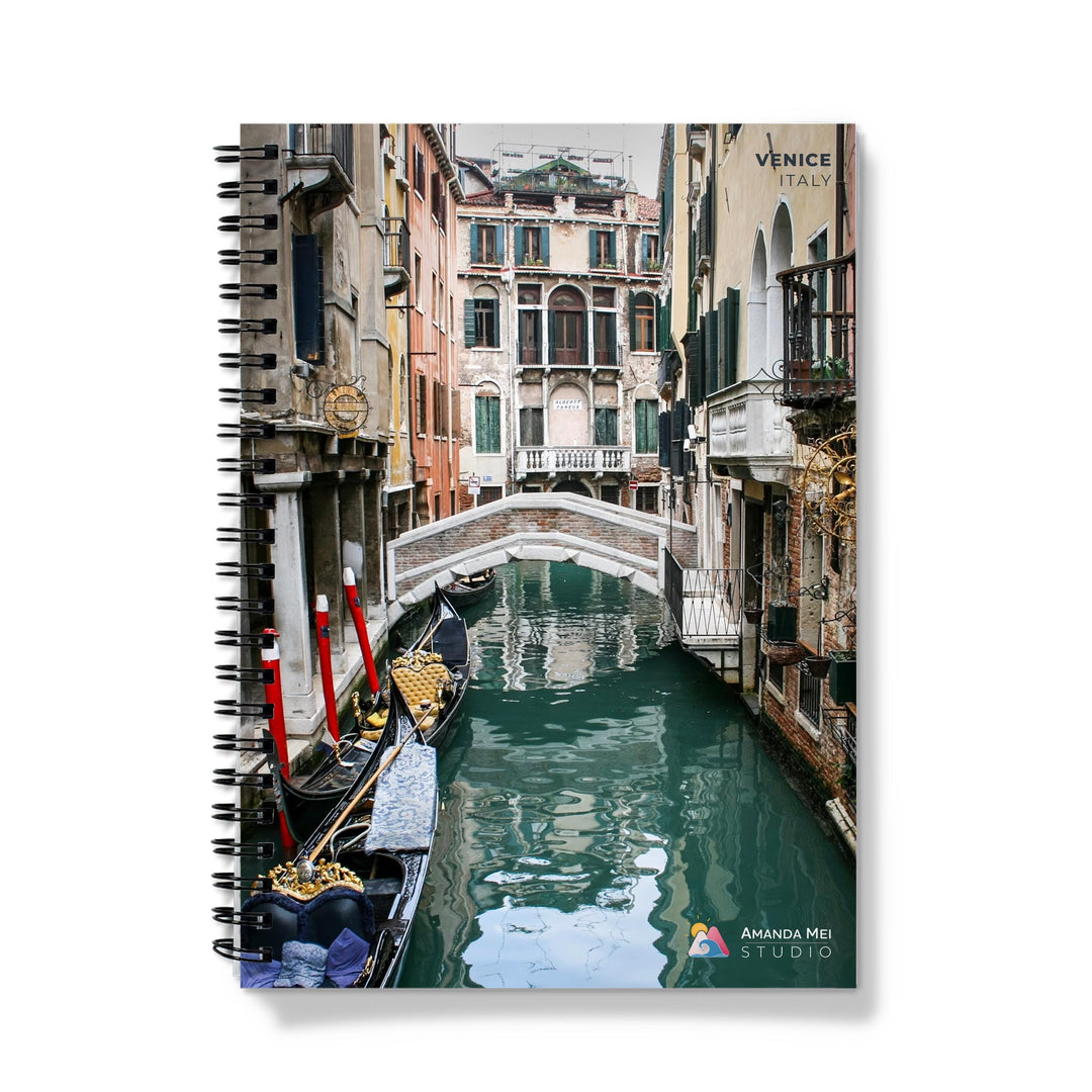 a gondola on a canal in venice, italy spiral notebook