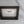 A black wooden frame with a white label inside, placed on a white background.