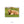 A brown, shaggy-haired animal, possibly a yak or a similar species, is lying down on a grassy field.