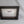 A black wooden frame with a white label inside, placed on a white background.