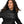 A woman with long curly hair wearing a black hoodie with a white graphic of a camera on it.