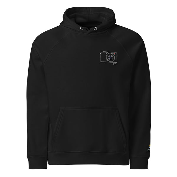 A black hoodie with a small camera design left chest on the front.