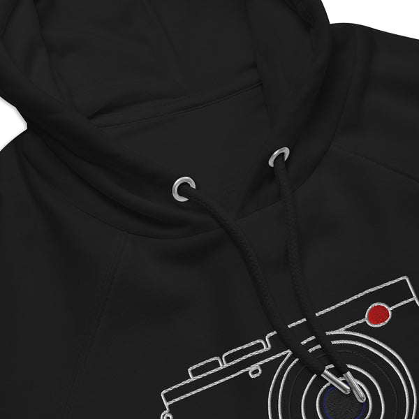 A close-up view of a black hoodie with a white camera design on the front.