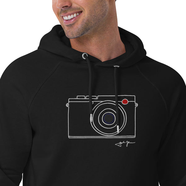 A man wearing a black hoodie with a white camera design printed on it.